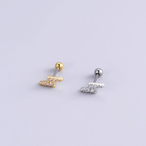 Detail of lightning bolt earrings in gold and silver finish with zircon stones