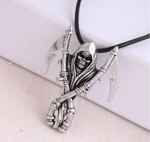 Macro view of silver reaper pendant with dual scythes on black leather cord