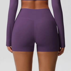 Detail of deep purple high-waisted yoga shorts with V-shaped stitching for booty lifting effect