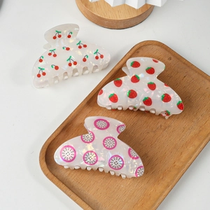 Three elegant hair claws with cherry, strawberry and dragon fruit patterns on pearl white base