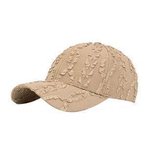 Beige baseball cap with seersucker pleated texture and adjustable strap for sun protection