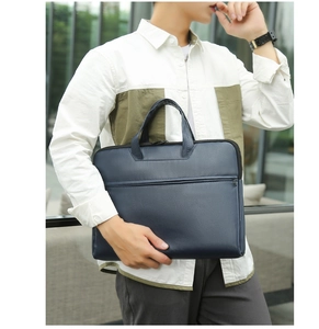 Detail of navy blue water-resistant laptop briefcase with dual handles and front zipper