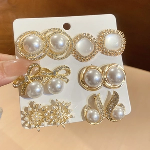 Detailed view of 6-pair gold earring set with pearls and rhinestones on card