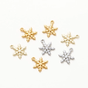 Detailed view of 18K gold-plated and silver snowflake pendants for jewelry making