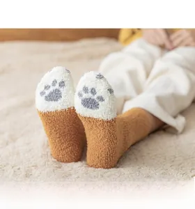Detail of coral fleece cat claw socks in caramel and white with plush texture