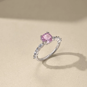 Macro detail of square cut pink gemstone ring in S925 sterling silver with side stones