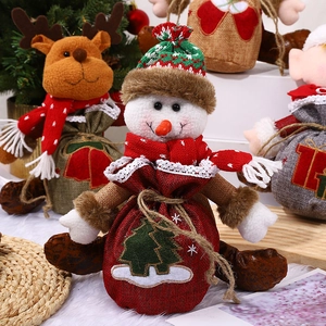 Plush Christmas drawstring gift bags featuring Santa, reindeer, and snowman designs