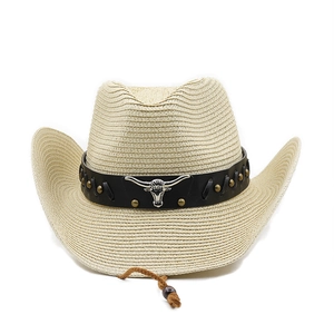 Close-up of straw cowboy hat featuring metal bull head logo and studded leather band
