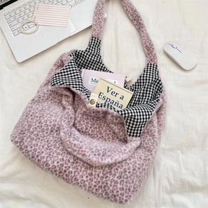 Detail view of pink leopard plush tote bag with checkered lining and magnetic closure