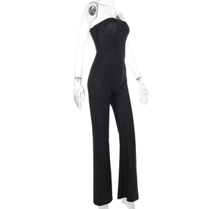 Detail of black bandeau jumpsuit with shimmering silver polka dots and wide leg cut