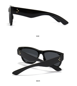 Cat eye sunglasses detail featuring gold star rivets on wide side and back temples