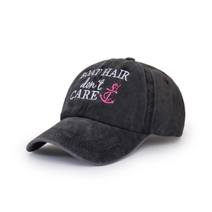 Detail of embroidered Boat Hair Don't Care text and anchor on washed grey baseball cap