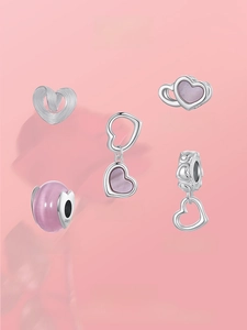Detailed view of 925 sterling silver heart charms and pink glass beads for bracelets