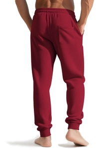 Detail of dark red waffle knit joggers showing the back pocket and elastic ankle cuffs