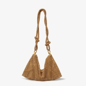 Detailed view of luxury gold rhinestone evening bag with sparkling beadwork and knots