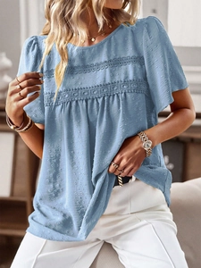Detail of blue textured short sleeve top with delicate lace trim and round neckline