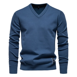 Detail of V-neck neckline and ribbed cuffs on navy blue knitted men's sweater