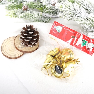 Set of golden 3cm Christmas decorative bells with pine cones and festive ornaments