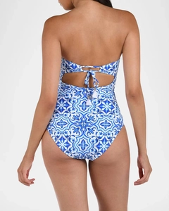 Detail of blue tile print swimsuit featuring back cut-out and white tassel ties