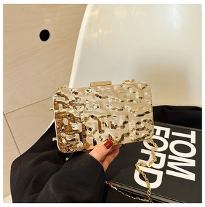 Detailed macro view of the gold hammered texture on this metallic evening clutch bag