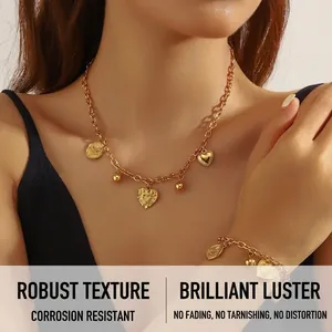 Detailed view of chunky gold-plated chain set with 3D heart and rose coin pendants