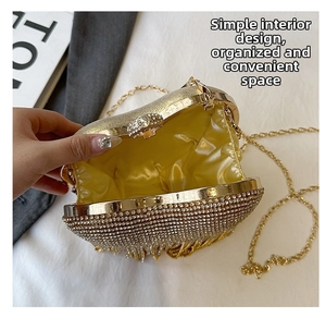 Detail of a luxury evening clutch with sparkling rhinestones and gold metal chain