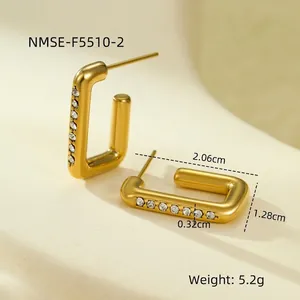 Macro shot of 18K gold plated rectangular earrings with white cubic zirconia inlay