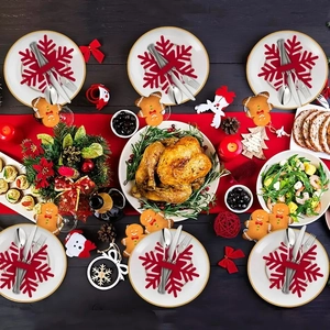 Overhead view of snowflake cutlery holders set on a festive Christmas dinner table