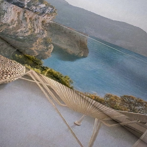 Close-up detail of Bohemian tapestry showing ocean landscape print and woven fabric texture