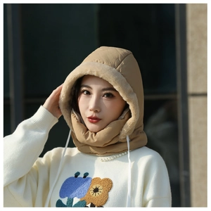 Close-up of a khaki winter hooded scarf with plush faux fur lining on a model.