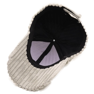Detail view of corduroy baseball cap showing black lining and soft textured fabric