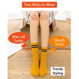 Women's yellow cotton knee high socks with black stripes shown in two wearing styles