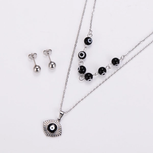 Detail of evil eye necklace set with silver fan pendant and black beaded chain