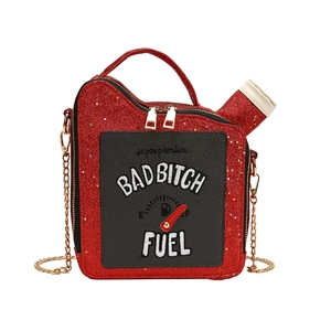 Detail view of red sequin fuel can handbag with BAD BITCH embroidery and chain strap