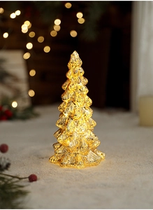 Close-up of golden mercury glass Christmas tree lamp with festive warm bokeh lights