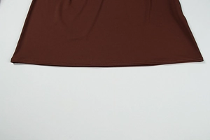 Close-up of chocolate brown dress hem showing smooth fabric and neat double stitching
