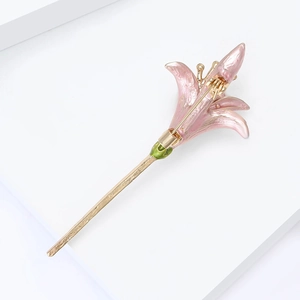 Macro view of pink enamel daffodil brooch with golden stem and detailed floral petals