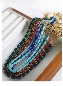 Detailed macro of multi-color natural stone bead jewelry sets in luxury display box