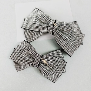 Elegant black bow hair clip featuring sparkling crystal rhinestones for a luxury look