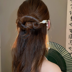 Détail d'épingle à cheveux chinoise avec bouton de fleur doré et glands de perles longs