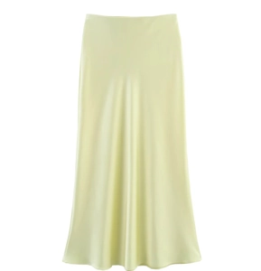 Detailed view of the smooth light yellow satin fabric texture of this midi skirt