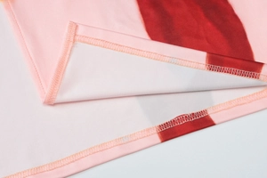 Macro shot of pink and dark red striped knit fabric with precise stitching detail
