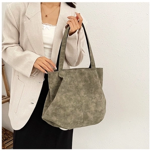 Detailed close-up of large deep moss green tote bag in premium matte frosted leather texture