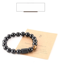 Detail of Virgo zodiac elastic bracelet with 8mm black beads and tiger eye stone