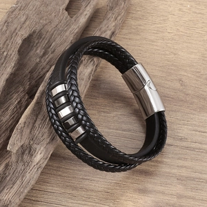 Men's multilayer braided leather bracelet with stainless steel magnetic clasp on wood