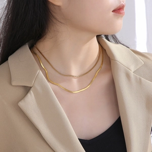 French style double-layer gold plated snake and box chain necklace worn by a model