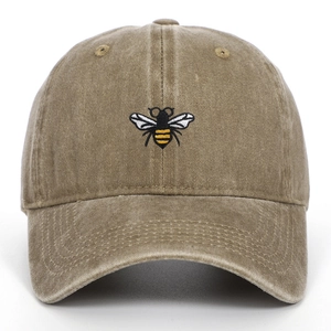 Close-up detail of vintage washed baseball cap with premium embroidered bee insect design