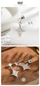 Macro detail of star cross stud earrings with sparkling cubic zirconia on a wooden tray