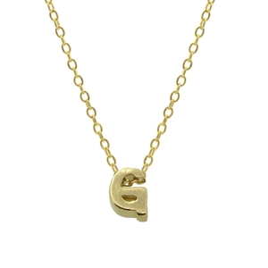 Detailed macro view of gold plated letter G pendant necklace with polished metal texture