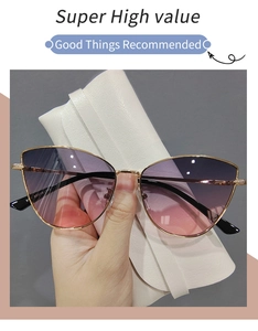 Detail of metal cat eye sunglasses with purple gradient lenses and white leather case